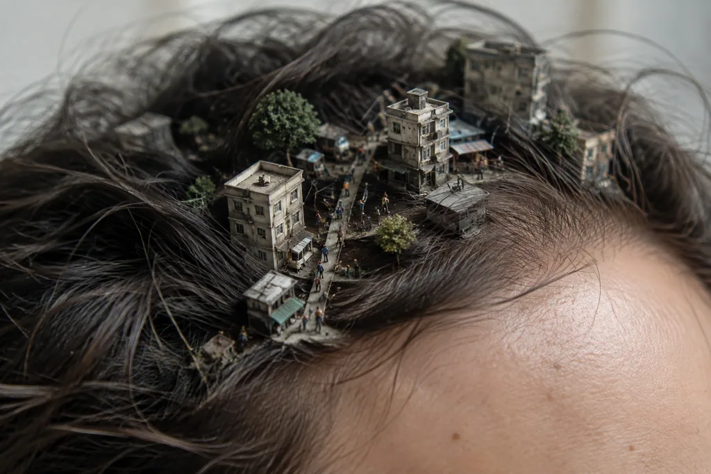 Macro photo of tiny people and streets hidden among strands of human hair