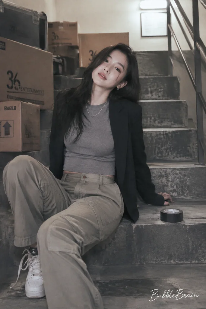 Film-look portrait of a Korean woman in a stairwell with soft overexposure